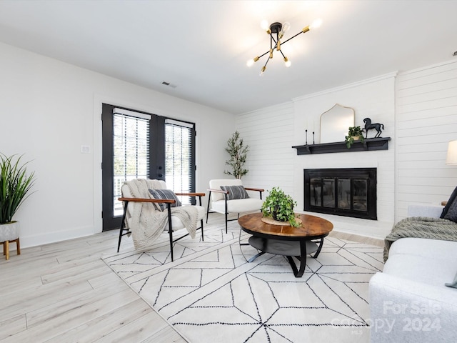 living room featuring a notable chandelier and light wood-type flooring