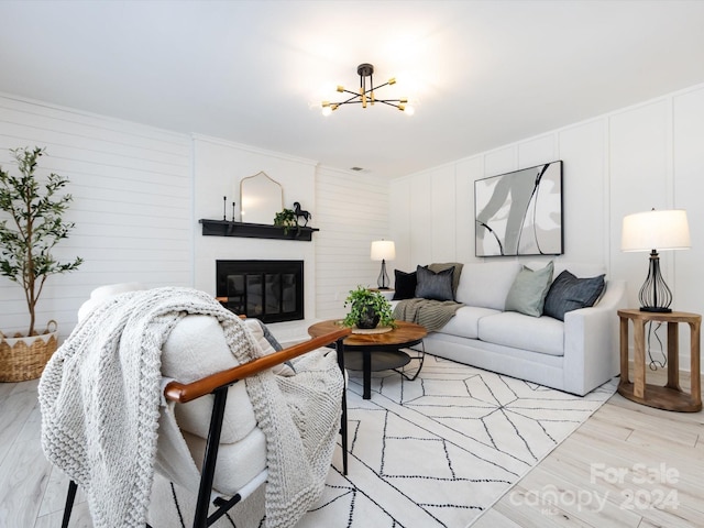 living room featuring light hardwood / wood-style flooring and an inviting chandelier