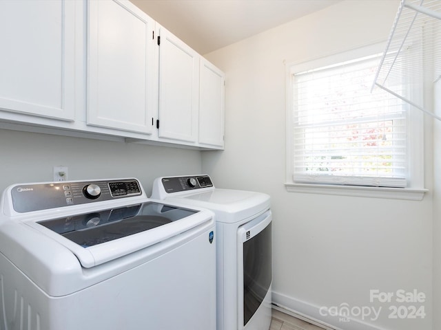 laundry area featuring cabinets and washing machine and clothes dryer