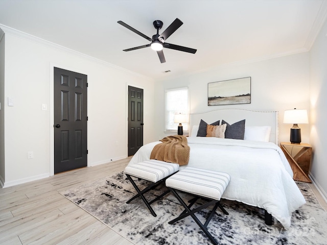 bedroom featuring crown molding, light wood-type flooring, and ceiling fan