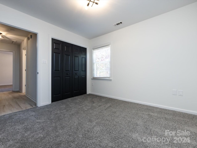 unfurnished bedroom with a closet and carpet floors