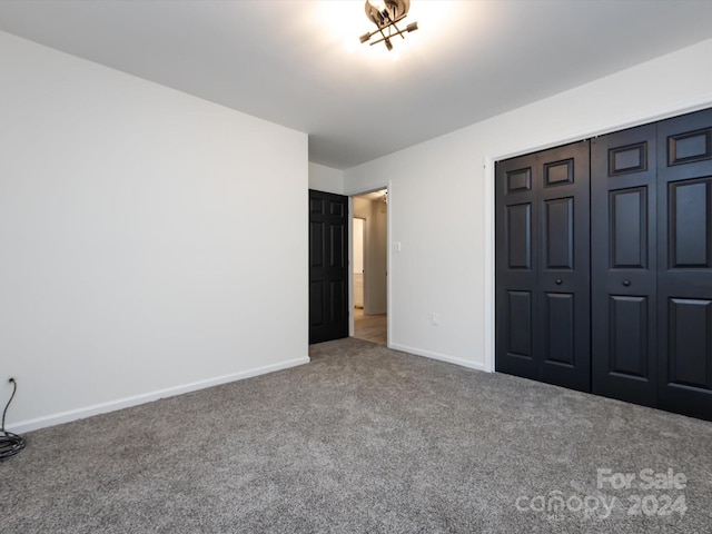 unfurnished bedroom with carpet and a closet