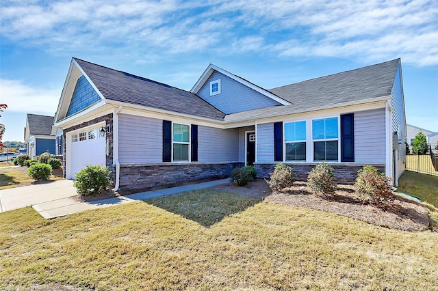 craftsman-style home with a garage and a front lawn