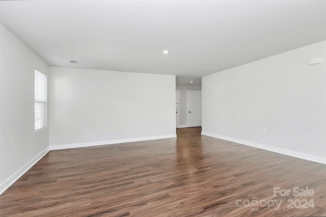 spare room with dark hardwood / wood-style flooring