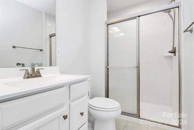 bathroom featuring vanity, tile patterned floors, toilet, and walk in shower