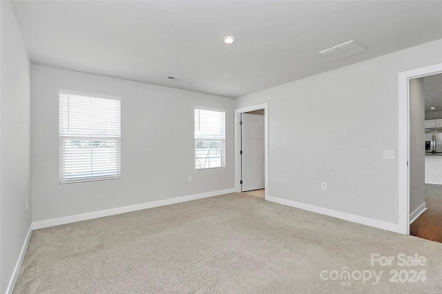 empty room with light colored carpet