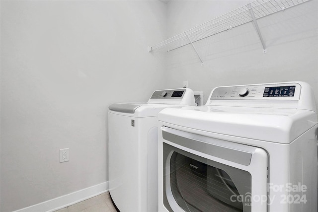 washroom with washing machine and clothes dryer