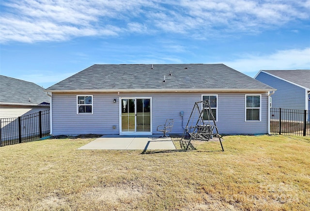 rear view of house with a yard and a patio area