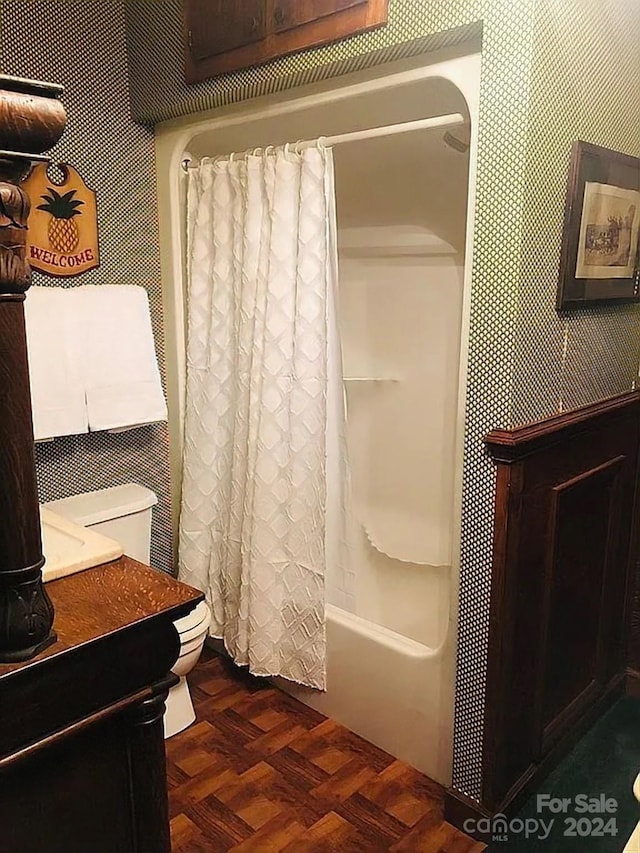 115 S Pearl St, Troy, NC 27371 - full bathroom featuring parquet flooring, vanity, shower / bath combo with shower curtain, and toilet