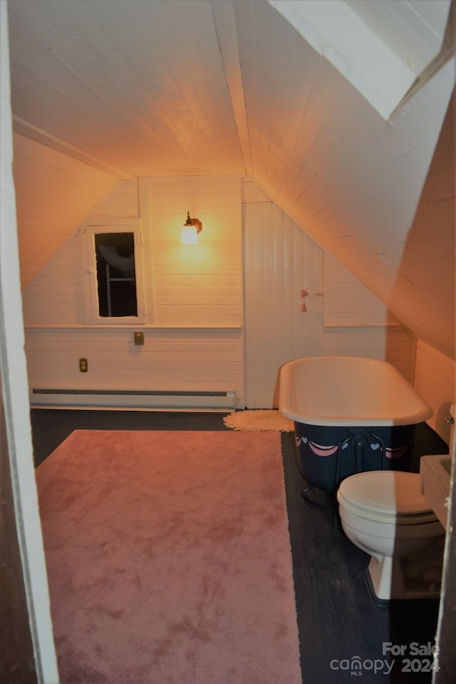 115 S Pearl St, Troy, NC 27371 - bathroom featuring wood walls, wood-type flooring, a baseboard heating unit, toilet, and vaulted ceiling with skylight
