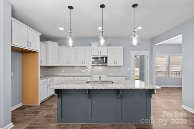 kitchen featuring white cabinetry, sink, and dark hardwood / wood-style floors