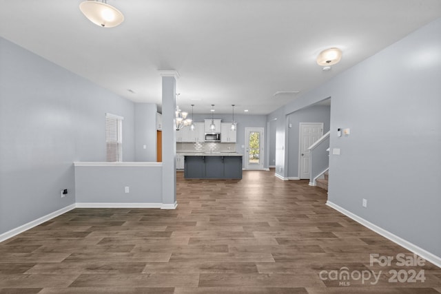 unfurnished living room featuring dark hardwood / wood-style flooring