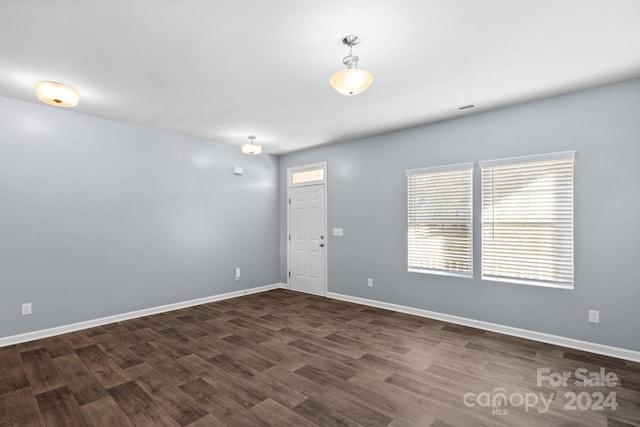 unfurnished room featuring dark wood-type flooring