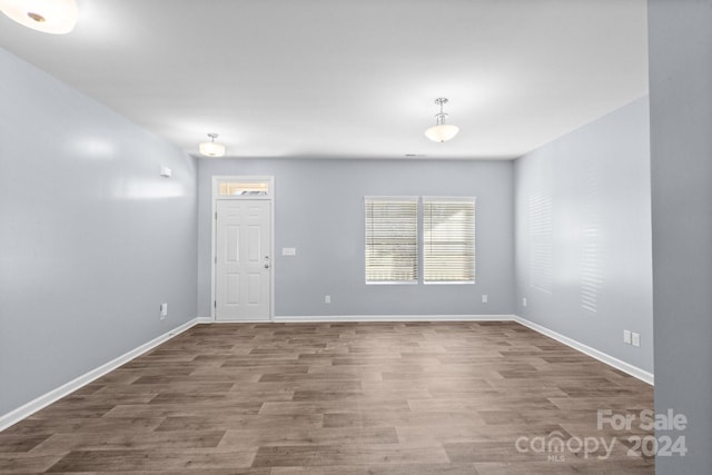 unfurnished room with hardwood / wood-style floors