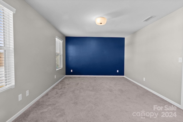 unfurnished room with light colored carpet