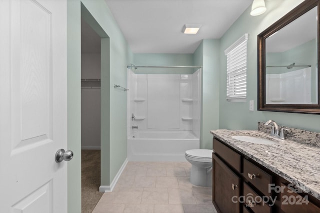 full bathroom with vanity, toilet,  shower combination, and tile patterned floors