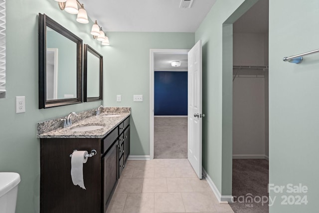 bathroom with vanity, toilet, and tile patterned flooring