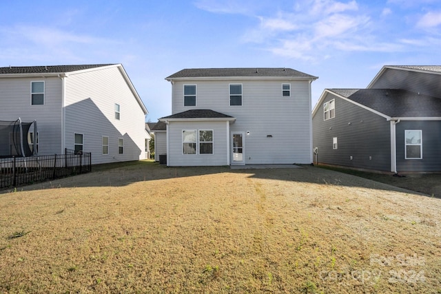 rear view of property with a lawn