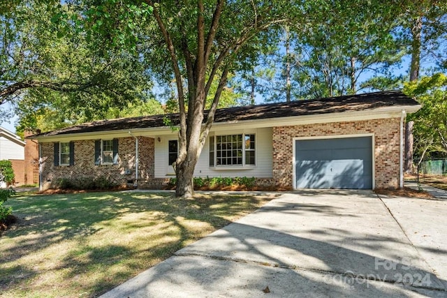 ranch-style home with a front lawn and a garage