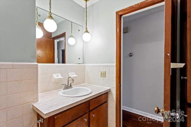 bathroom with vanity, tile walls, and hardwood / wood-style floors