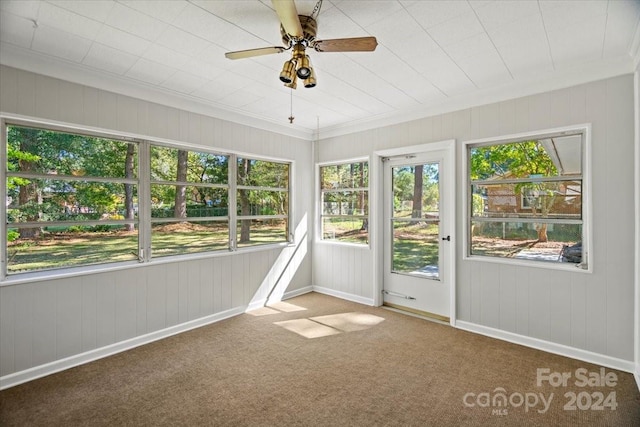 unfurnished sunroom with ceiling fan