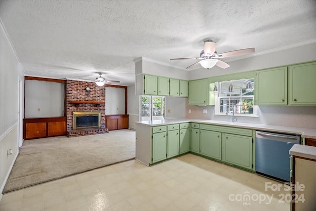 kitchen featuring dishwasher, a healthy amount of sunlight, green cabinetry, and a fireplace