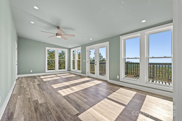 unfurnished sunroom with ceiling fan, french doors, and lofted ceiling