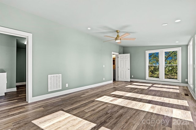 empty room featuring ceiling fan, dark wood-type flooring, and vaulted ceiling