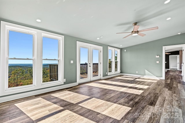 unfurnished living room with french doors, ceiling fan, lofted ceiling, and wood-type flooring