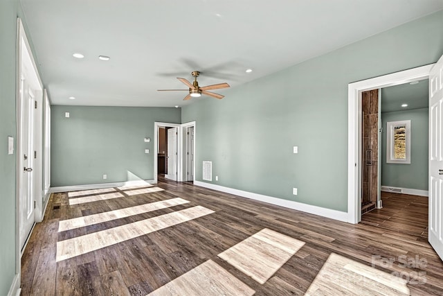 empty room featuring ceiling fan and dark wood-type flooring