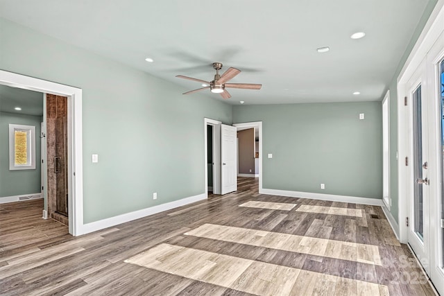 unfurnished bedroom featuring ceiling fan, french doors, and light wood-type flooring