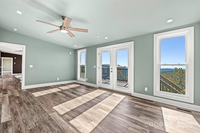 spare room featuring french doors, dark hardwood / wood-style floors, ceiling fan, and lofted ceiling