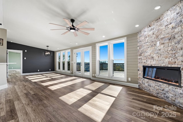 6230 Pine Ridge Dr, Connelly Springs, NC 28612 - unfurnished living room featuring a fireplace, wood finished floors, and plenty of natural light