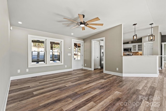 6230 Pine Ridge Dr, Connelly Springs, NC 28612 - unfurnished living room featuring baseboards, vaulted ceiling, ceiling fan, and dark wood-type flooring
