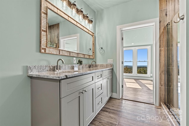 6230 Pine Ridge Dr, Connelly Springs, NC 28612 - full bathroom with double vanity, a sink, baseboards, and wood tiled floor