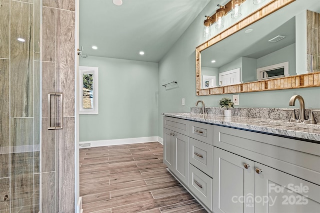 6230 Pine Ridge Dr, Connelly Springs, NC 28612 - full bath with baseboards, double vanity, a sink, and wood finish floors
