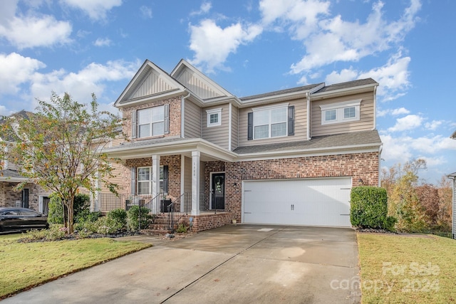 craftsman-style home featuring a garage, a front lawn, and covered porch