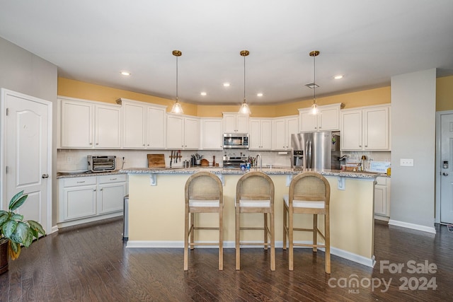 kitchen with white cabinetry, a center island with sink, and stainless steel appliances