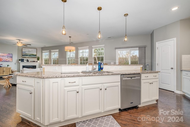 kitchen with dishwasher, white cabinets, sink, dark hardwood / wood-style floors, and pendant lighting