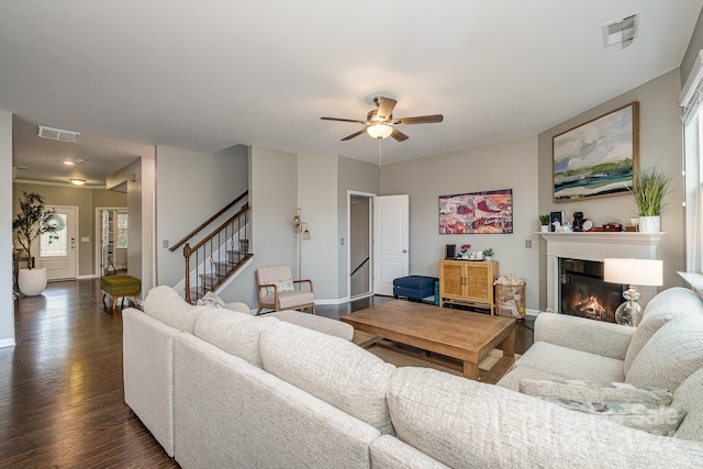 living room featuring dark wood-type flooring, a wealth of natural light, and ceiling fan