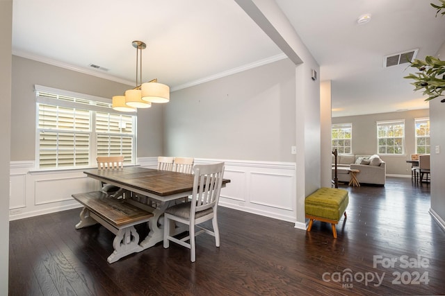 dining area featuring dark hardwood / wood-style floors and crown molding