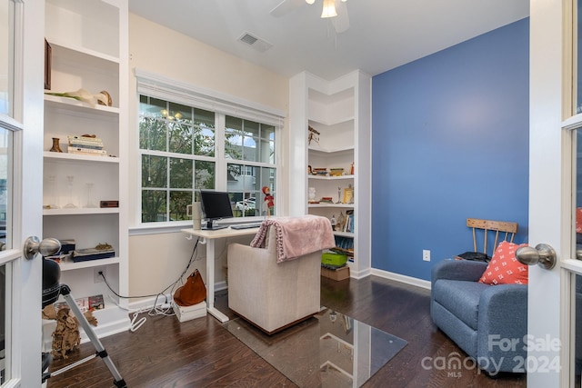 office featuring dark hardwood / wood-style flooring, ceiling fan, and built in desk