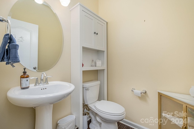 bathroom featuring hardwood / wood-style floors and toilet