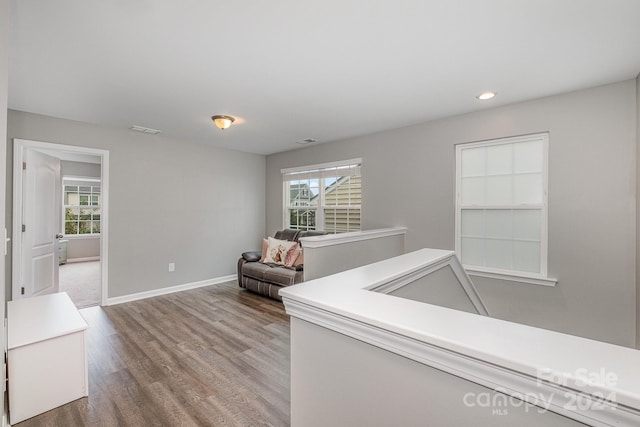 hallway with hardwood / wood-style floors