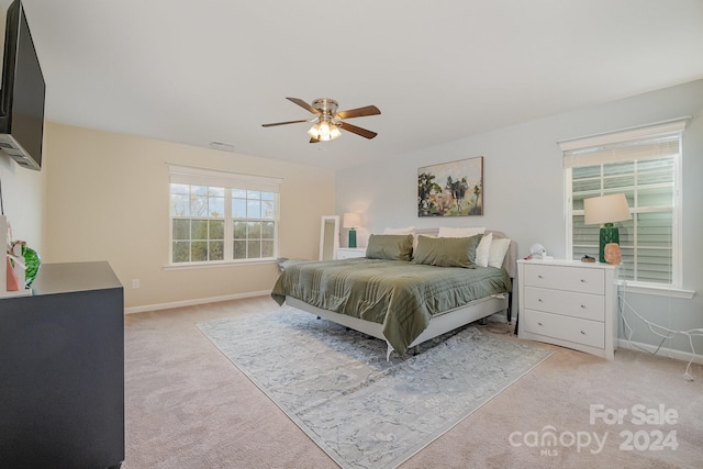 bedroom featuring light carpet and ceiling fan