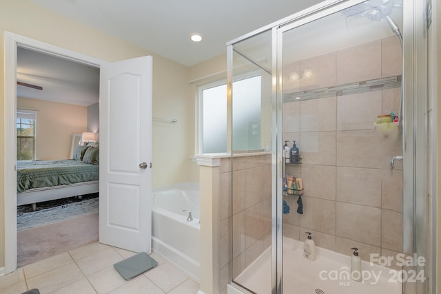 bathroom with independent shower and bath and tile patterned floors