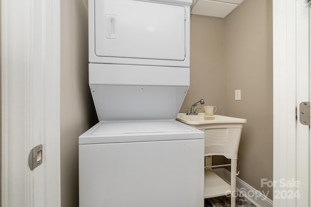 laundry area featuring stacked washer / drying machine