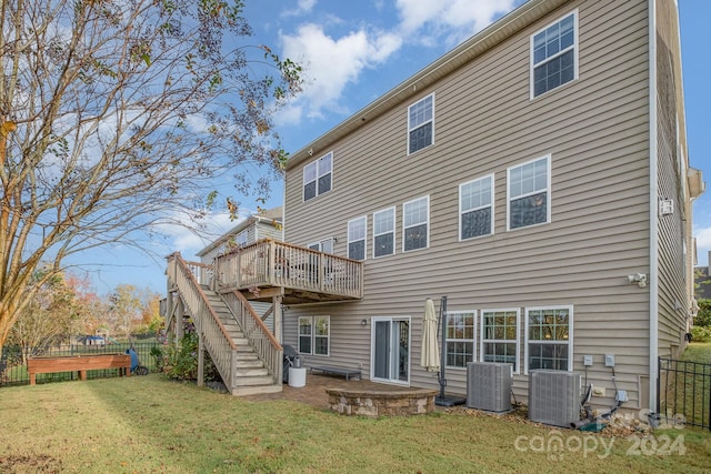 back of house with cooling unit, a lawn, and a deck