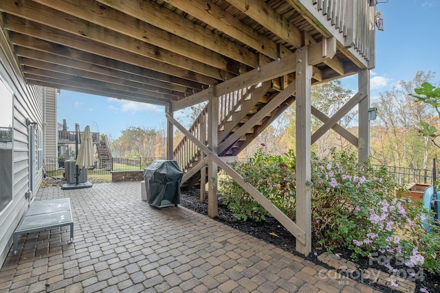 view of patio / terrace featuring cooling unit and a grill