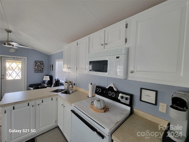 kitchen with lofted ceiling, kitchen peninsula, sink, white cabinetry, and white appliances